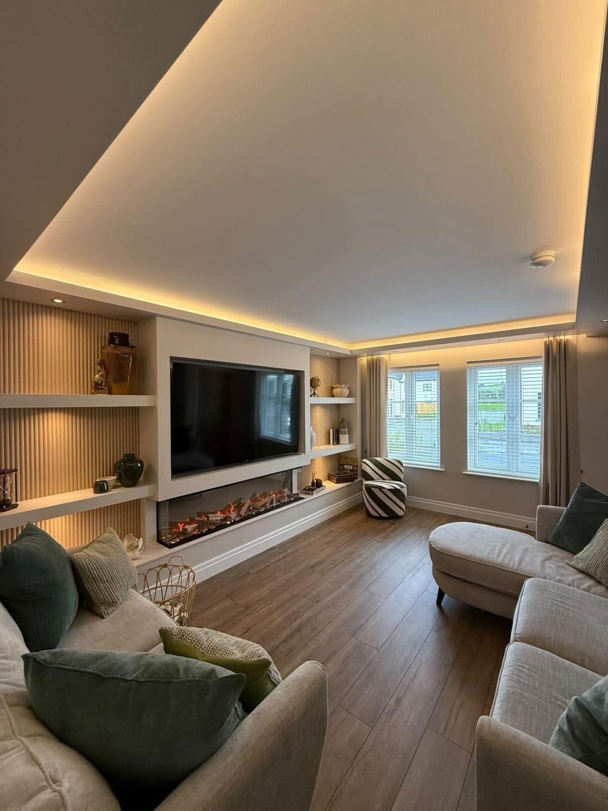 Media wall with linear fireplace, integrated shelving and recessed ceiling lighting